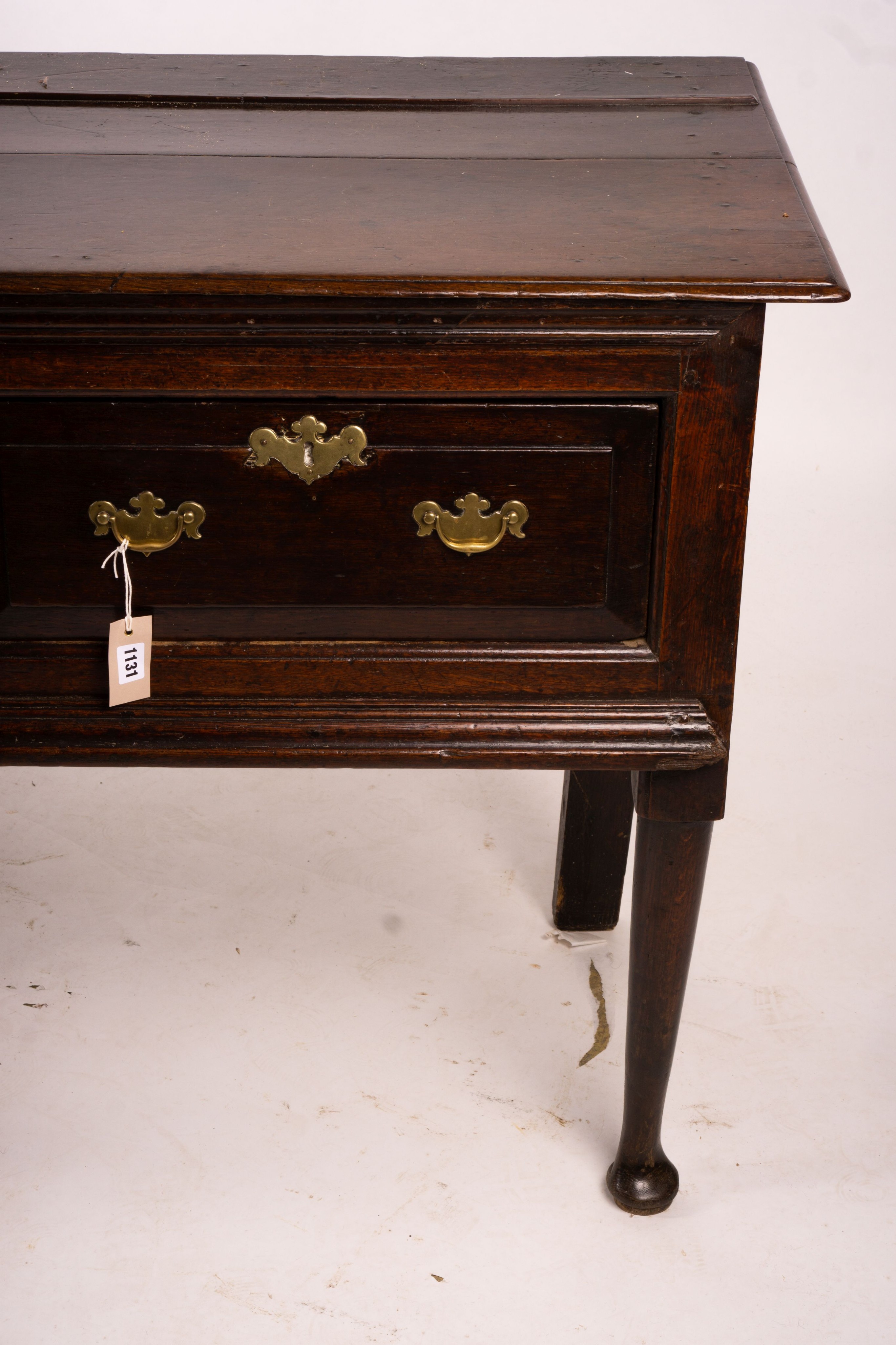 An 18th century oak low dresser on pole turned legs and pad feet, length 198cm, depth 53cm, height 88cm